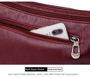 Dettaglio della tasca posteriore con zip sulla borsa a tracolla in pelle rossa scura