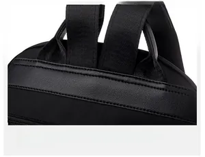 Detail shot of black nylon backpack showing precision stitching and leather reinforcement