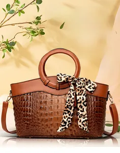 Detail of vintage crocodile embossed tote bag featuring a decorative leopard print silk scarf