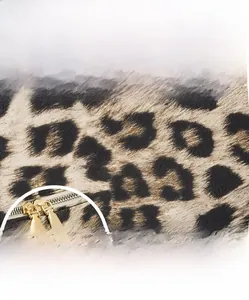 Vue détaillée de la texture léopard en similicuir et double fermeture éclair du sac à dos