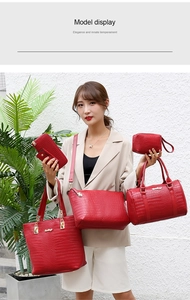 Detail showing 5-piece red faux crocodile leather handbag set with tote and crossbodies