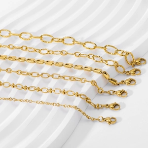 Six assorted minimalist 18k gold plated stainless steel chain bracelets on white background