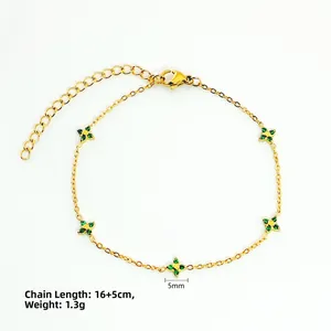 Detailed view of 5mm green zircon clover pendants on a gold-tone chain bracelet