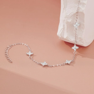 Detailed view of silver clover bracelet with five sparkling zircon-encrusted flower pendants