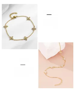 Detailed close-up of gold titanium steel four-leaf clover bracelet with sparkling zircon stones