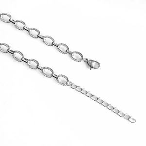 Macro view of textured oval links on silver stainless steel chain with lobster clasp
