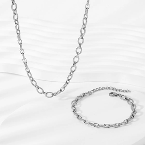 Silver stainless steel hip hop chain set with oval screw thread links on white background