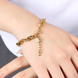 Chunky gold 18K stainless steel chain bracelet with a sparkling paved round charm