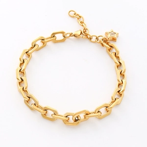 Detail of 18K gold stainless steel chain with star charm and lobster clasp closure