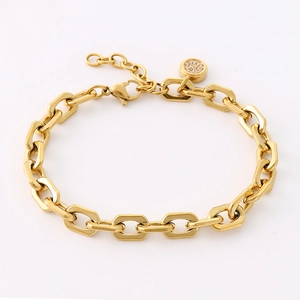 Macro view of 18K gold-plated oval link bracelet with a sparkling paved zircon charm