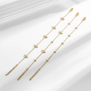 Elegant gold clover bracelet with white cubic zirconia and adjustable lobster clasp
