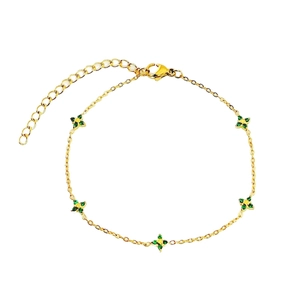 Elegant gold clover bracelet with green zircon stones on a minimalist link chain