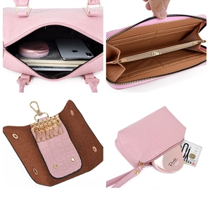 Detail of pink croc-embossed bag set including tote and wallet with gold hardware