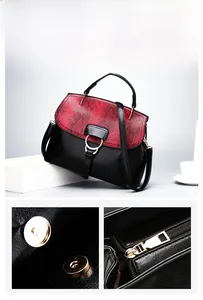 Detail of magnetic buckle and zipper on two-tone shell handbag with snakeskin pattern