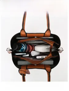 Top view of large brown leather tote bag interior showing spacious multi-compartment storage