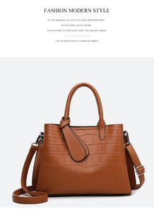 Macro shot of brown crocodile embossed leather texture on large capacity tote bag