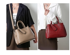 Detail of crocodile embossed leather tote bag showing texture and hardware details
