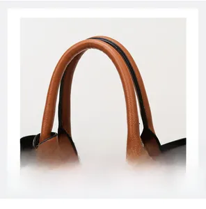 Close-up of brown litchi pattern handle with detailed stitching and black oil edge
