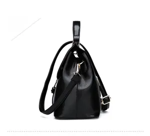 Positive side show of black shell tote bag with glossy finish and gold metal hardware