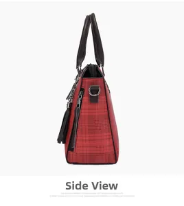 Detail view of red plaid PU leather handbag with black handles and long side tassels