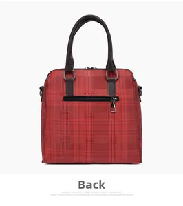 Rear view of red plaid tote bag with dark brown leather handles and exterior zipper pocket