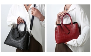 Detail view of crocodile pattern tote bags in classic black and wine red colors