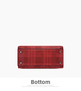 Detailed bottom view of red and black tartan bag with four protective silver metal studs