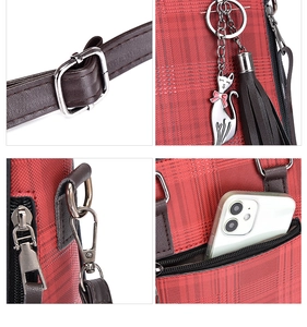 Detail view of red plaid handbag featuring silver buckles, cat charm, and tassel accents