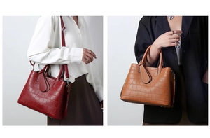 Detail of crocodile embossed tote bag in burgundy and yellow with adjustable straps