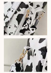 Détails de la fermeture éclair dorée et des crochets sur le sac à dos imprimé vache tendance