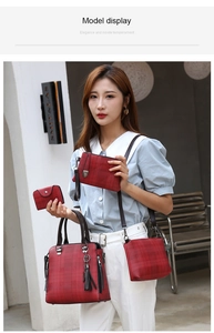 Detail of red plaid 4-piece handbag set featuring metal tassel charm and brown handles