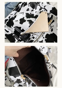 Détail du sac à dos en similicuir à motif vache avec doublure brune et compartiment spacieux