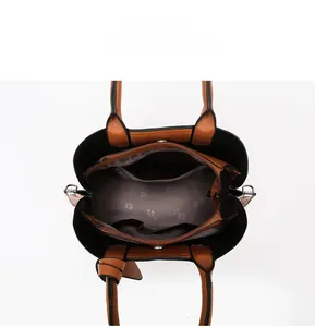 Top view of brown leather tote bag interior with multiple compartments and rose pattern lining