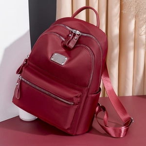 Burgundy oxford fabric backpack for women with adjustable straps and front zip pockets