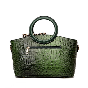 Green faux-crocodile tote bag with circular handle and leopard print scarf accent