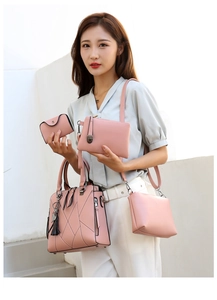 Pink leather 4-piece handbag set including tote with cat tassel, crossbody and clutch
