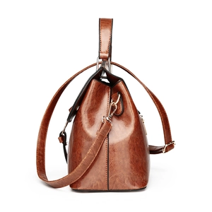 Elegant brown oil wax leather shell bag with gold hardware and top handle for women