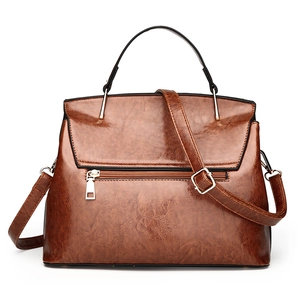 Brown oil-wax PU leather shell bag with black handle and gold hardware on white background