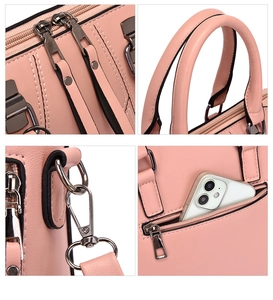 Detail view of pink pebbled faux leather handbag with gunmetal hardware and zippers