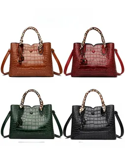 Showcase of four crocodile embossed handbags with leopard print silk scarf handles