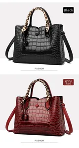 Detail of crocodile pattern handbags in black and wine red with leopard print scarves