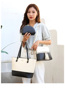 Detailed close-up of a 3-piece bag set with black and white tote, crossbody, and clutch