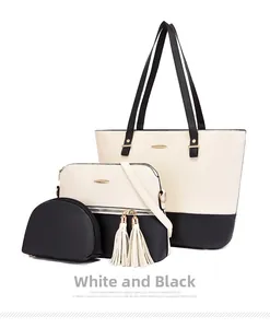Close-up of three-piece black and white pebble faux leather handbag set with gold hardware