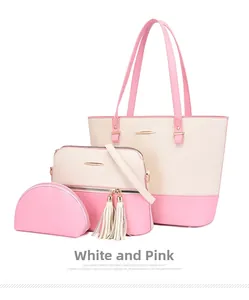 Close-up of three-piece handbag set in white and pink with tassels and golden hardware