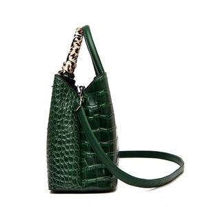 Green crocodile embossed leather handbag with leopard scarf detail and crossbody strap
