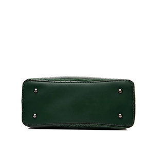 Dark green crocodile pattern handbag showing bottom base with four silver metal rivets