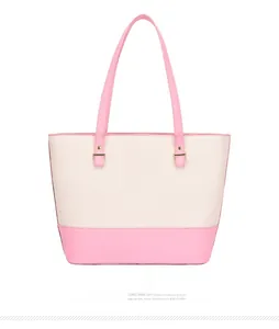 Detail of pink and beige two-tone tote bag with gold hardware and textured PU leather