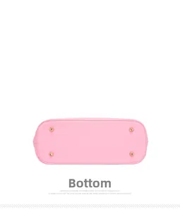 Detailed bottom view of pink tote bag featuring crossgrain leather and gold metal feet