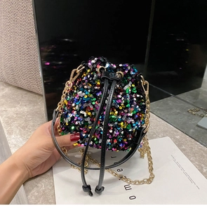 Detailed macro view of vibrant sequins and black leather drawstring on bucket bag