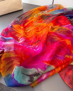 Detailed texture of vibrant multi-color abstract print scarf with sheer fabric
